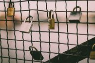 Padlock on Black Metal Fence