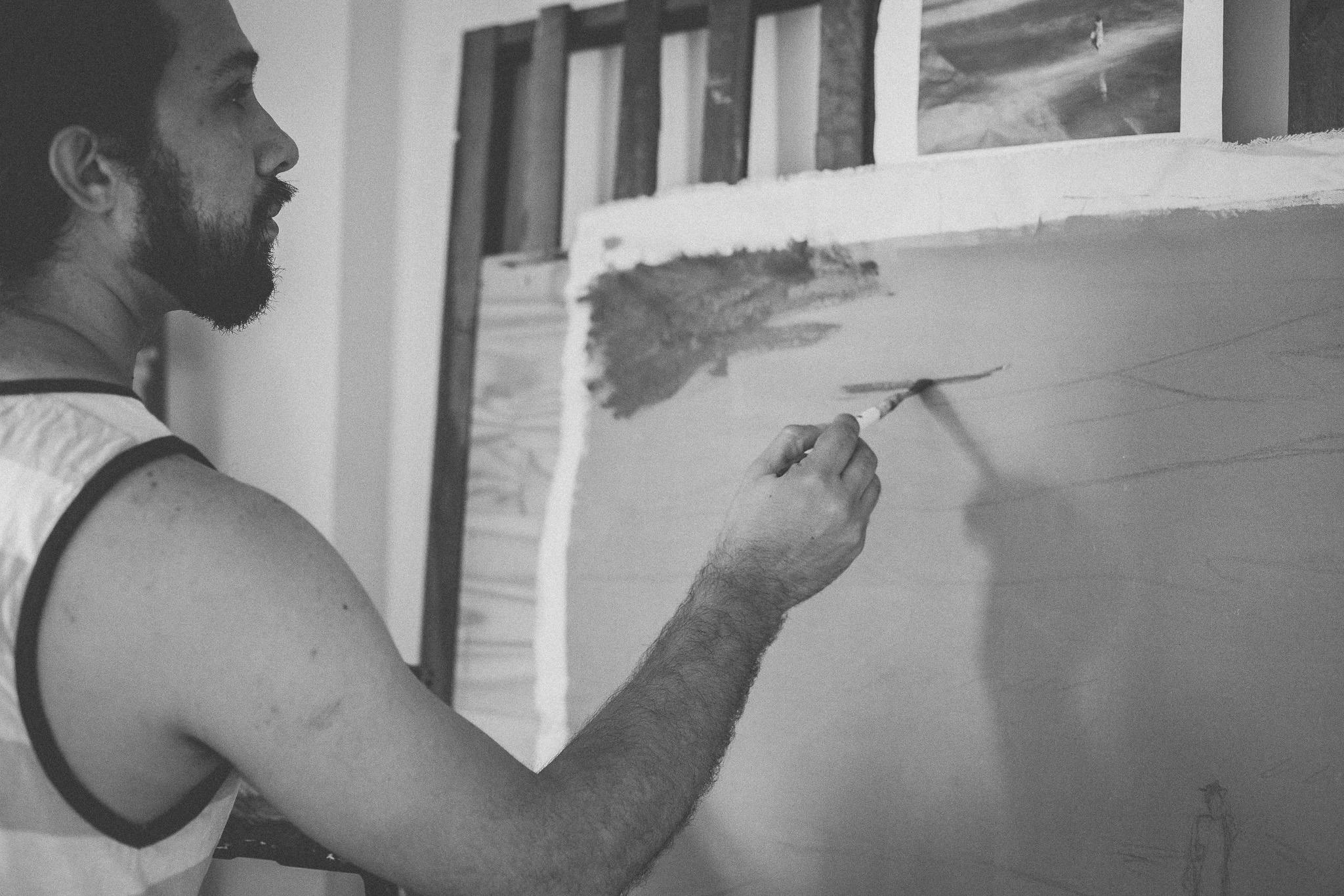 Grayscale Photo of Man Painting