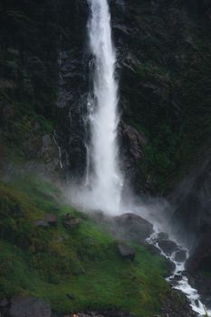 Big Waterfall In Mountain Valley Coming from High Rocky Wall