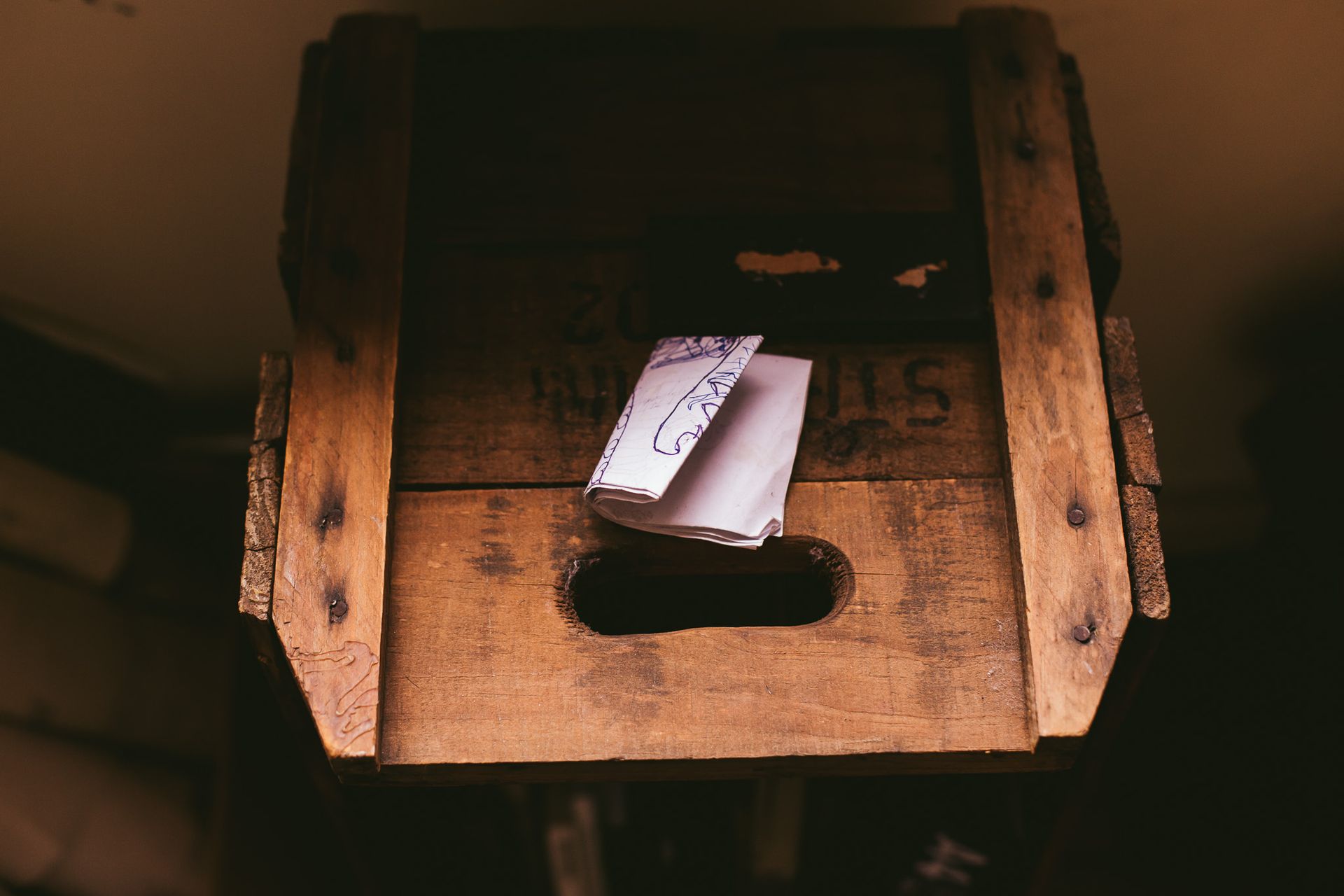 White Printing Paper on Brown Wooden Crate