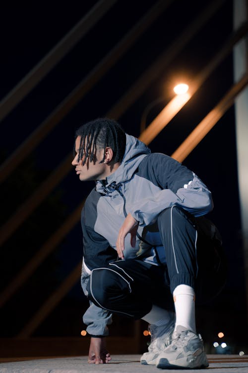 Man with Dreadlocks Hair Wearing Black and Gray Jacket 