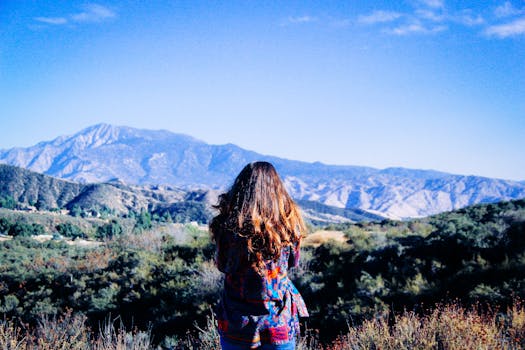 Enjoy the breathtaking view of the San Bernardino Mountains in Yucaipa, CA, with a woman basking in nature's beauty.