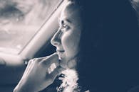 黑白相间的艺术侧影，一位沉思的女人在车里