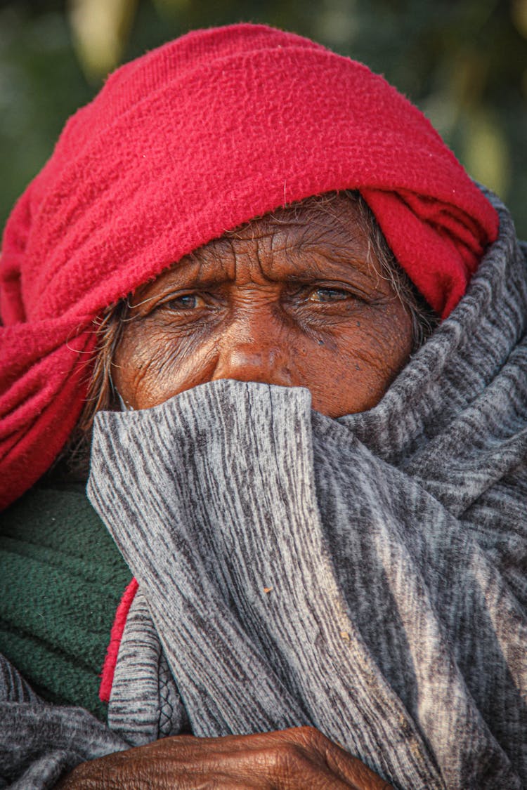 Closeup Of A Senior Woman Covered With Red And Gray Clothing