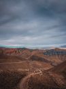 Road Vanishing in Red Desert Mountains