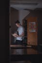 A Man in White Shirt Holding a Book