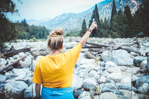 Free Woman in Yellow Shirt Holding Cola Bottle Stock Photo