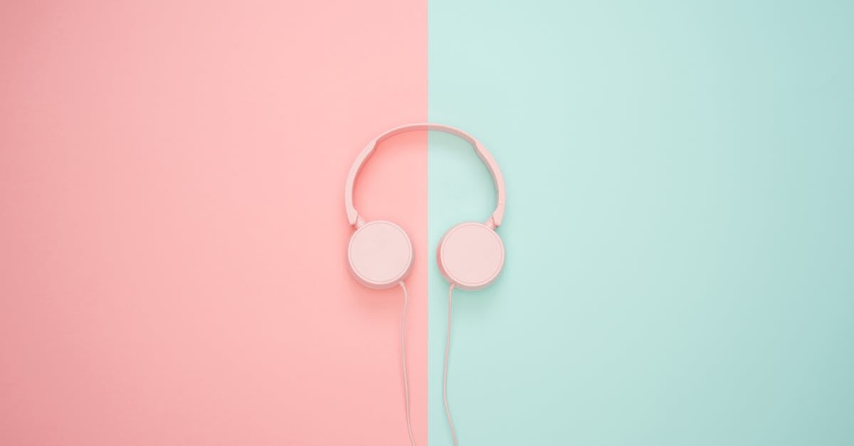 Pink Corded Headphones on pink and teal Wall
