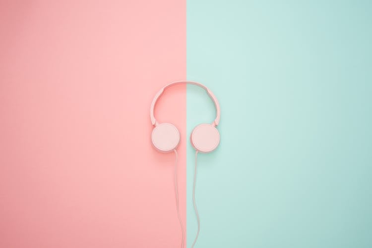 Pink Corded Headphones On Pink And Teal Wall