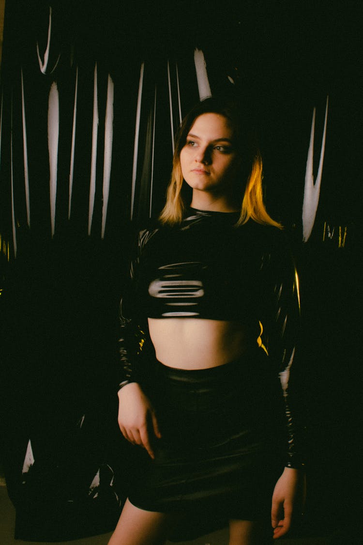 Girl Posing With Black Plastic Textile