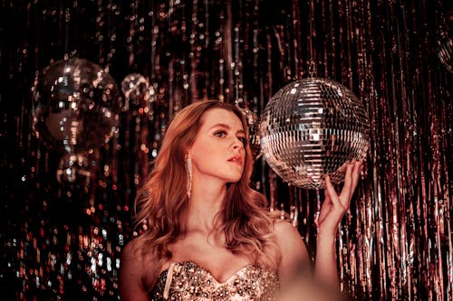 A Woman Holding a Disco Ball 