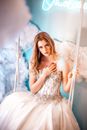 Woman in a Ball Gown Sitting on a Swing