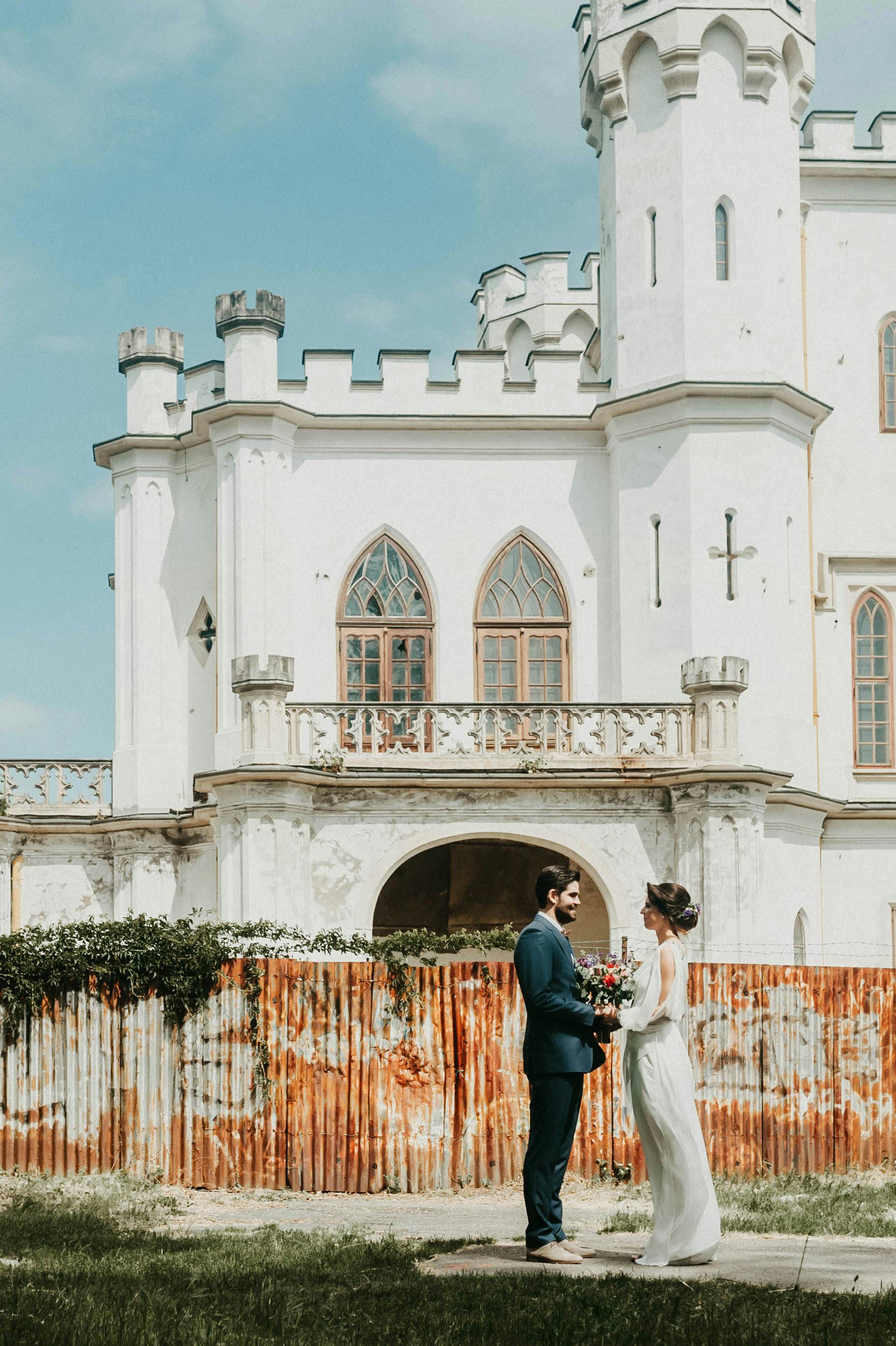 a wedding photography of a bride and groom outside the church