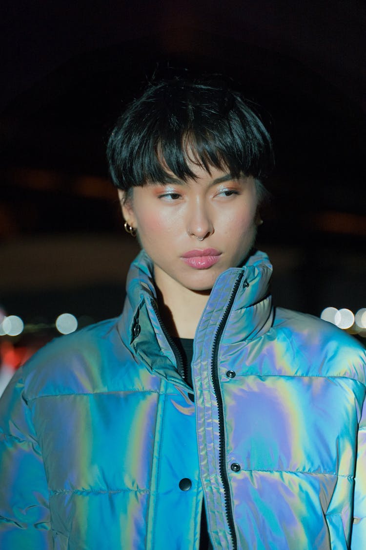 A Pretty Woman With Short Hair Wearing Blue Shiny Jacket
