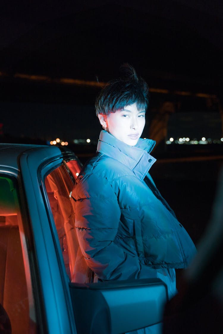 A Woman Leaning On A Car