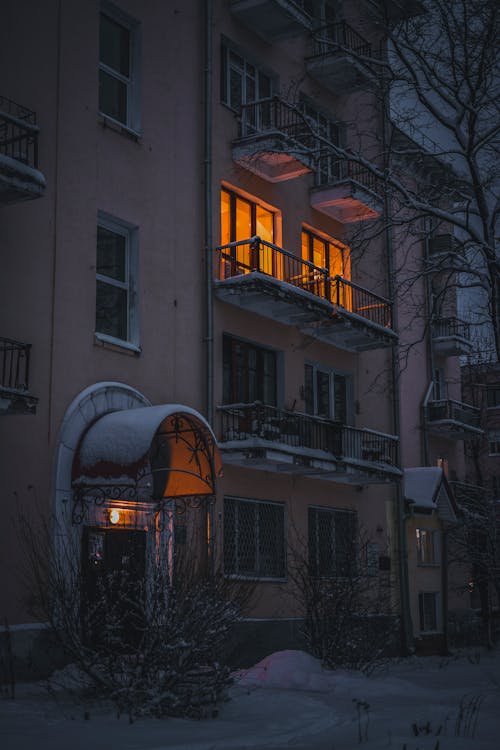 A Brown  Concrete Building with Yellow Lights