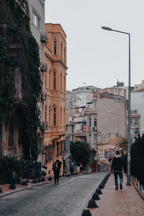 Free Charming street in Istanbul with historic buildings and pedestrians, showcasing the city's vibrant urban life. Stock Photo