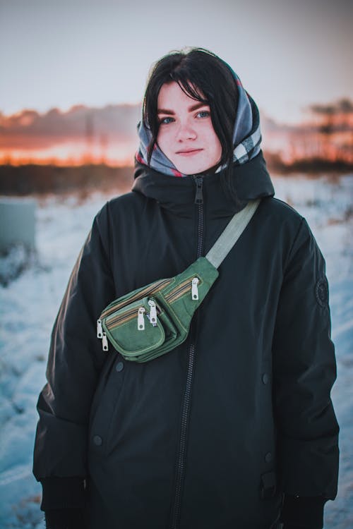 A Woman in Black Hoodie Jacket with a Green Fanny Pack