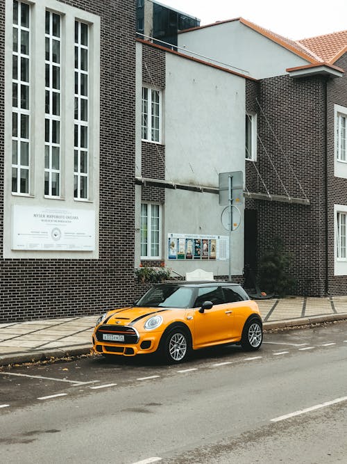 Yellow Car Parked on the Side of the Road