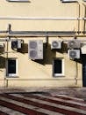 A Concrete Building with Outer Units of Split Type Aircons Mounted on Wall