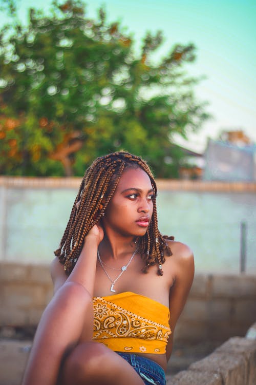 Free Shallow Focus Photo of Woman in Yellow Tube Top Posing Stock Photo