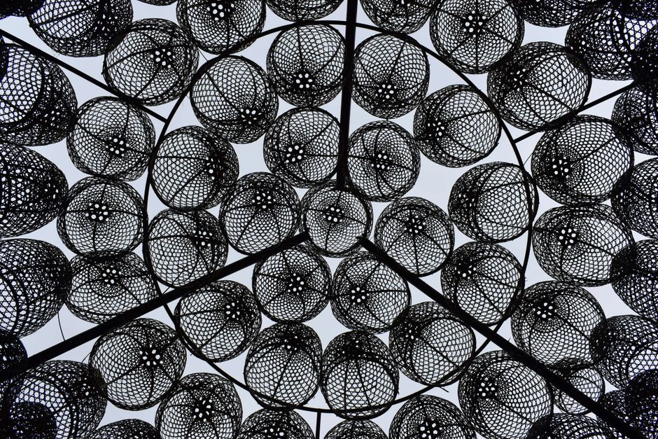 A mesmerizing view of a geometric patterned ceiling in Bali, Indonesia, showcasing artistic intricacy.