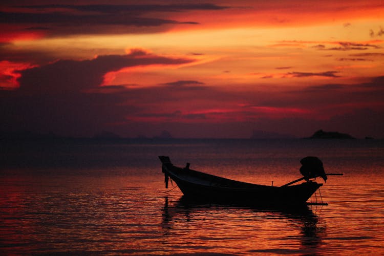 Sunset Over Boat On Sea