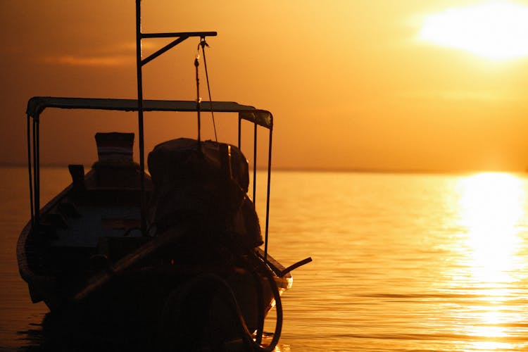 Sunlight Over Boat On Sea Shore