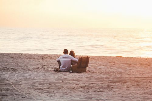 Couple watching sunset on the beach