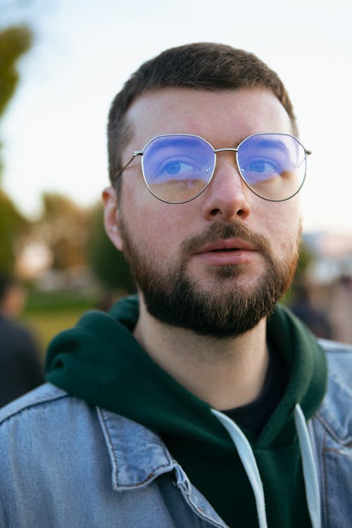 Man in Blue Denim Jacket Wearing Eyeglasses