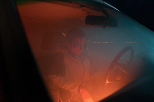 Free Man in Hoodie Jacket Sitting in the Car Stock Photo