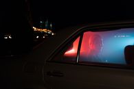 Woman Sitting at the Back Seat of a Car
