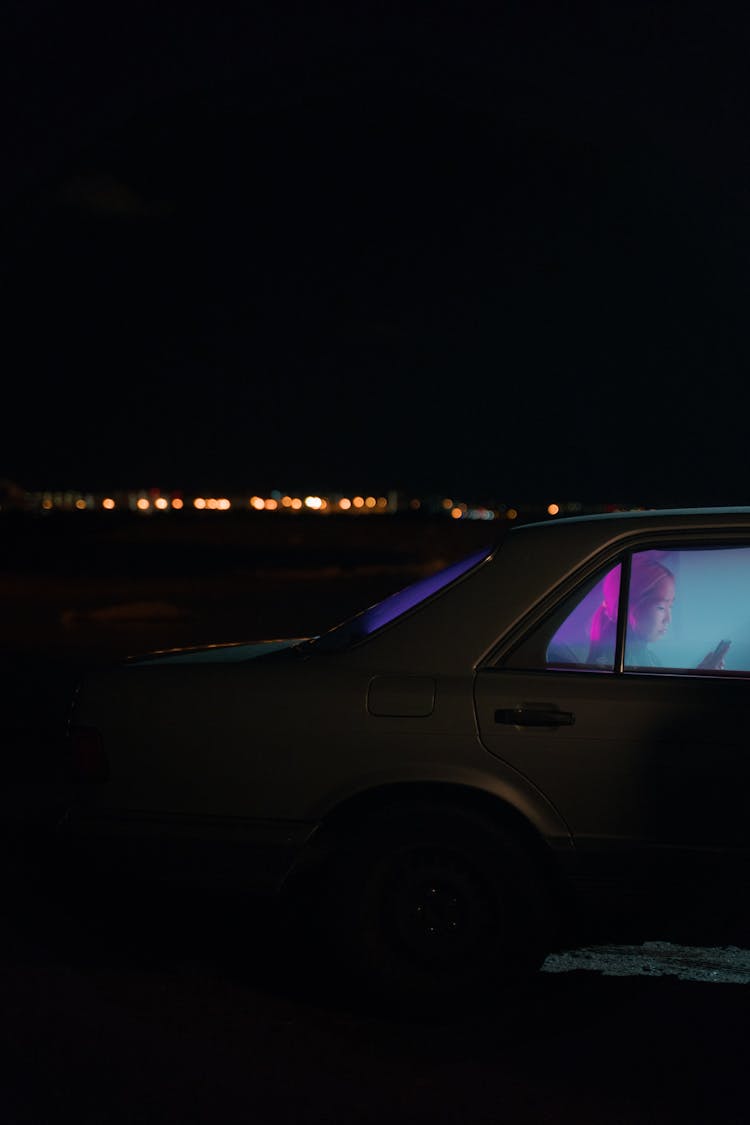 Woman Sitting In Car At Night