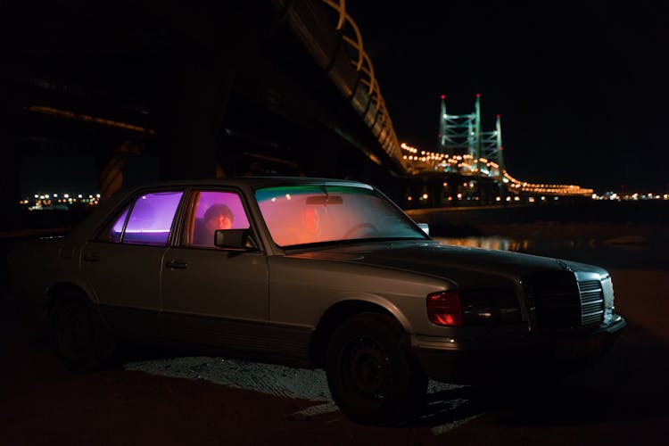 Car Under Illuminated Bridge