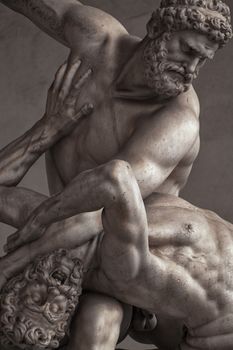 Intricate marble sculpture depicting a dramatic scene of titans in battle, located in Florence, Italy.