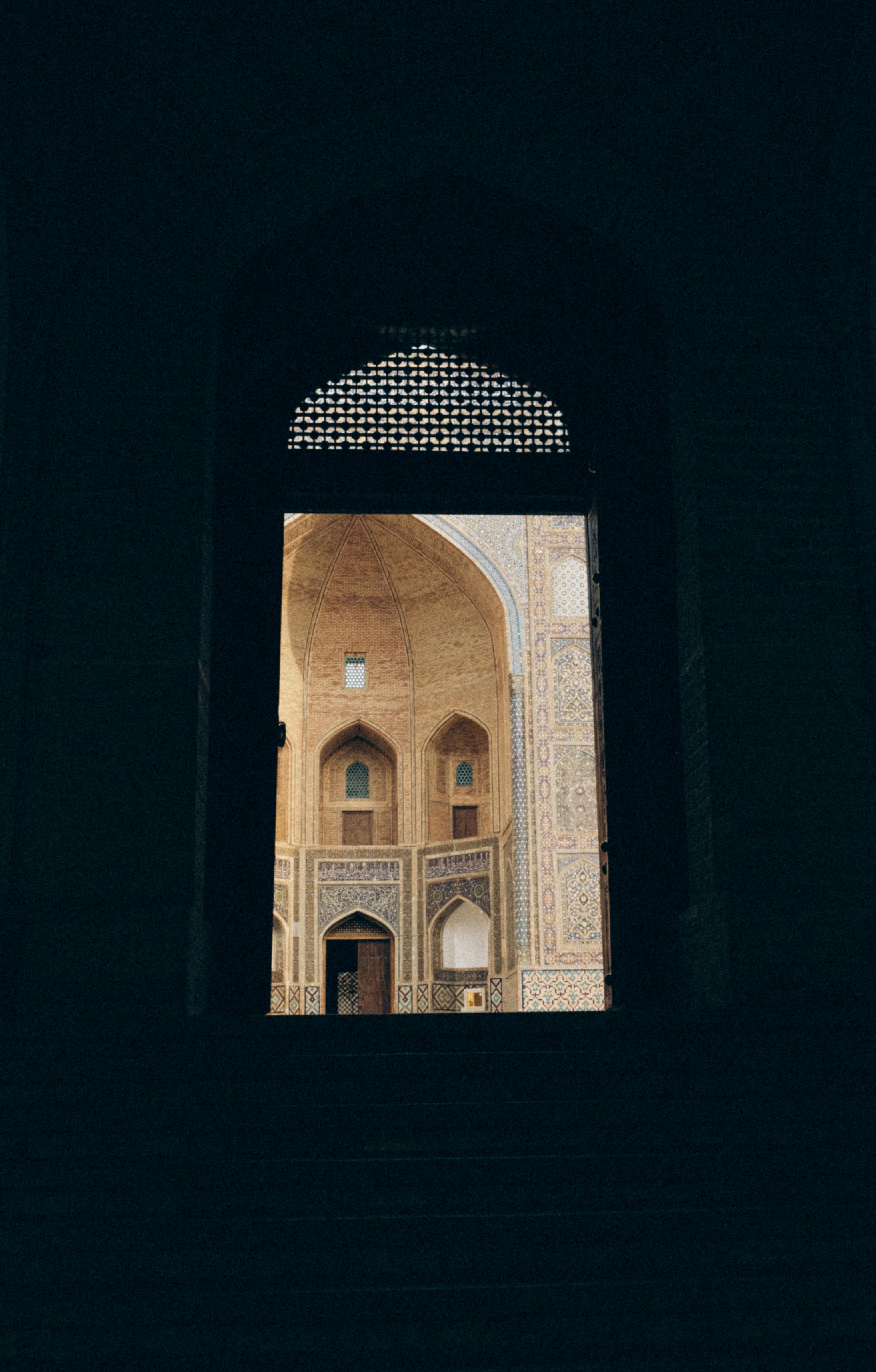 A captivating view through a dark entrance, revealing a stunning historic architectural building.