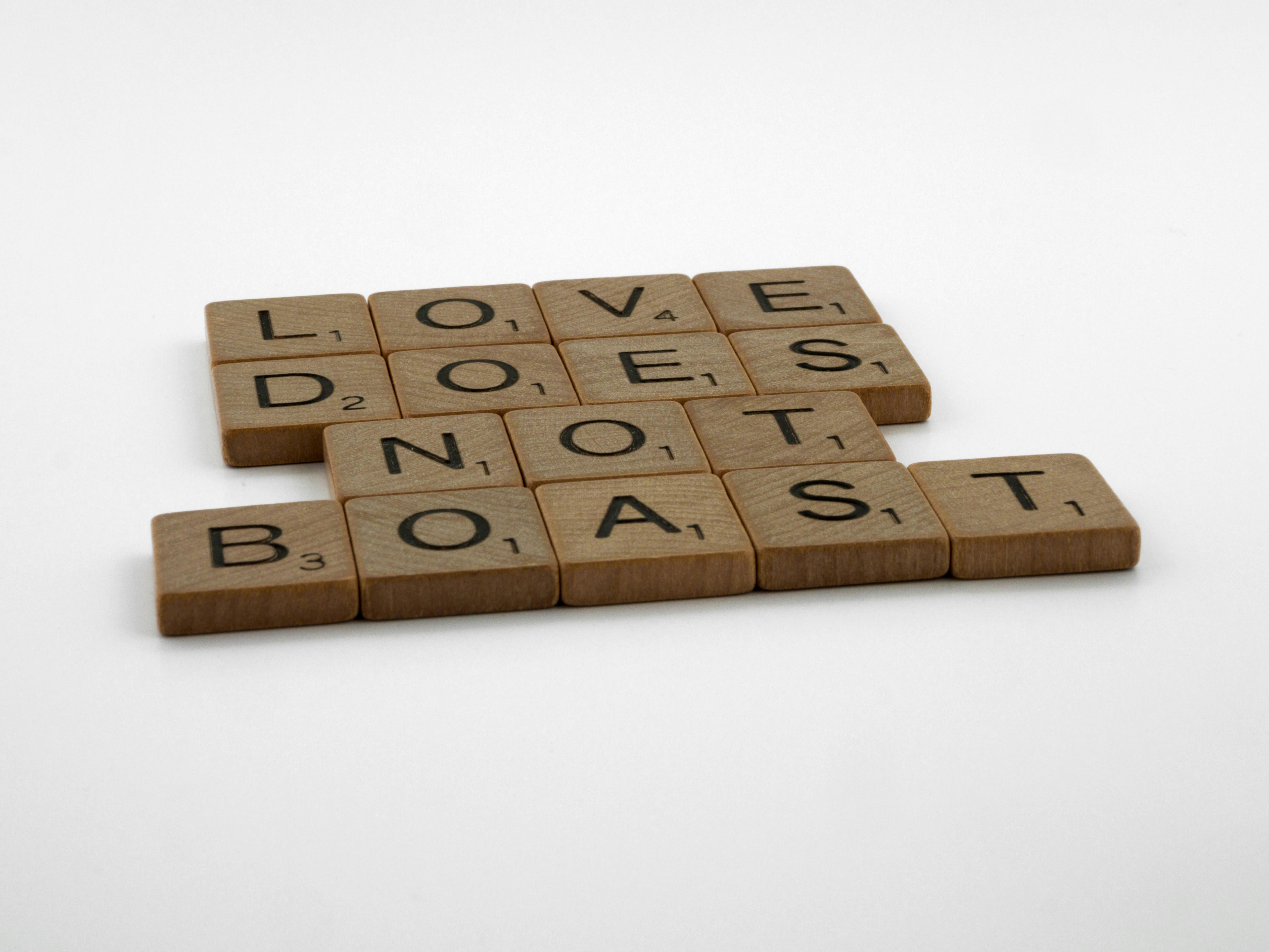 close up shot of scrabble tiles on a white surface