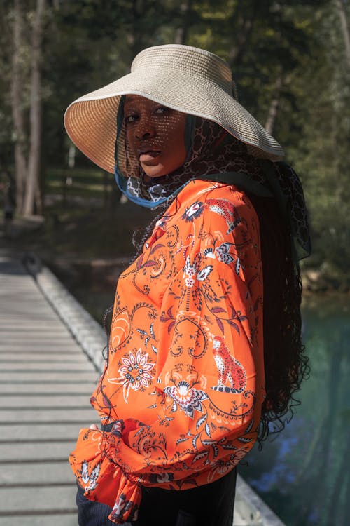 A Woman in Orange Floral Long Sleeves