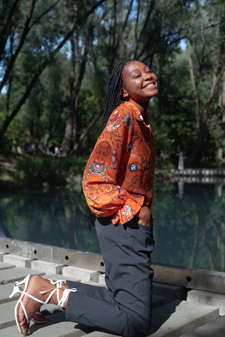 A Woman Smiling While Kneeling 