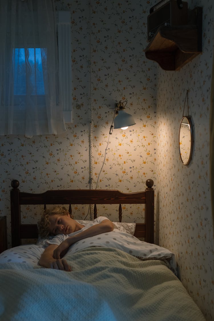 Blond Teenage Boy Lying In Bed