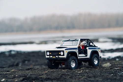 Close-Up Shot of a Toy Car on a Dirt Road