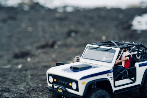 Close-Up Shot of a Toy Car on a Dirt Road