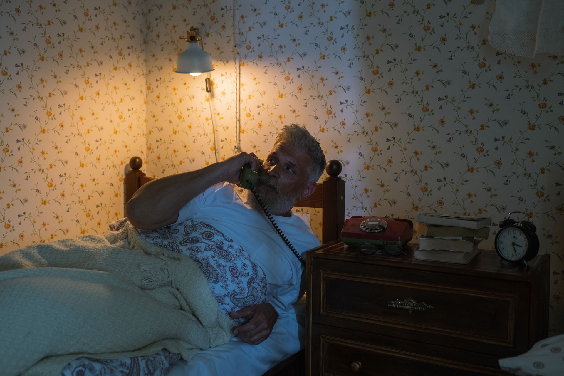 Man Laying in Bed Talking on Phone