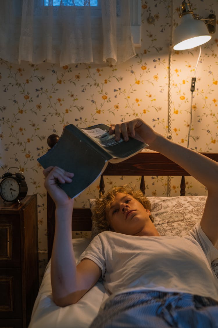 Teenager Reading In Bed At Night