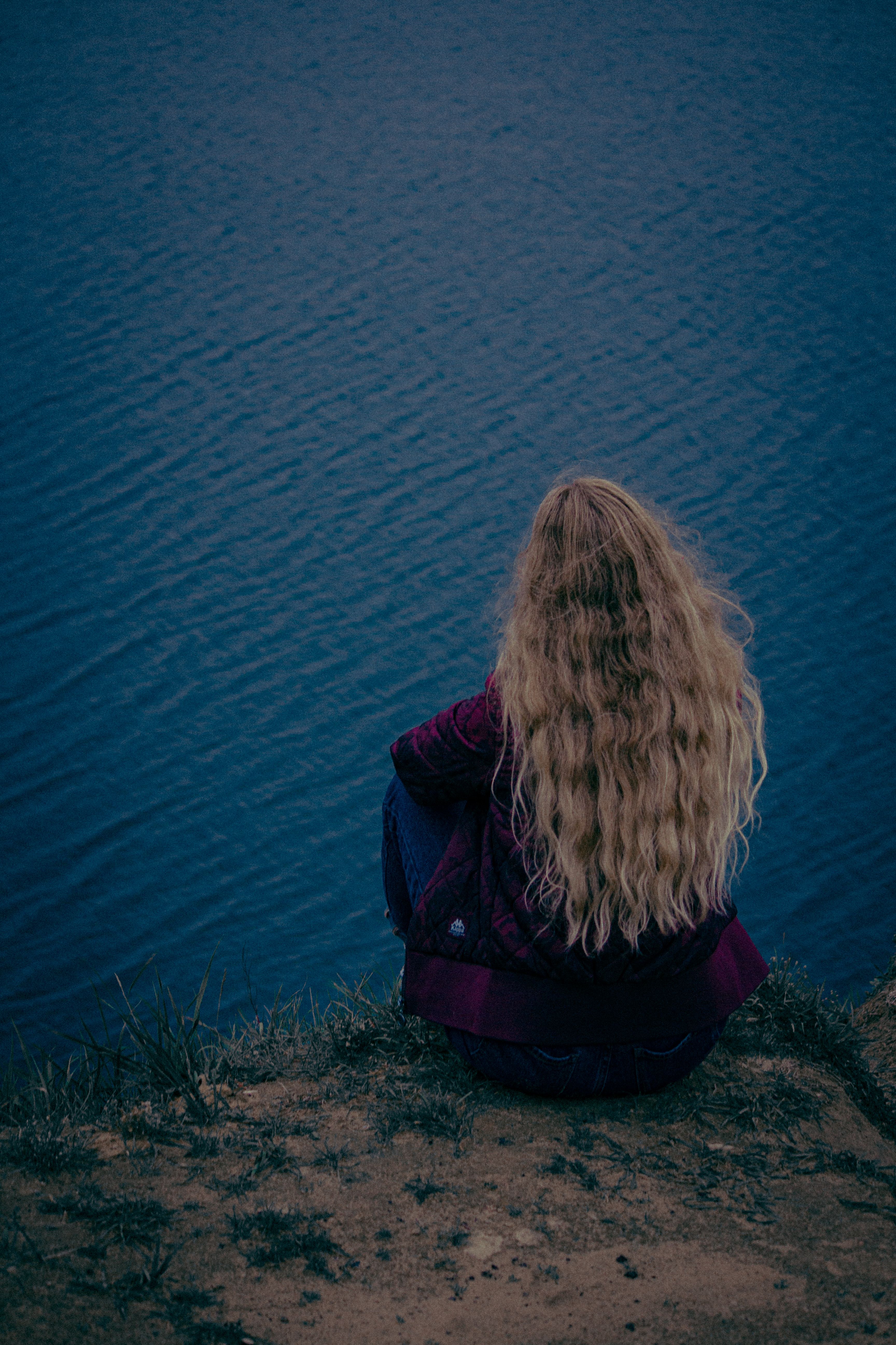 Girl Sitting by the Water · Free Stock Photo
