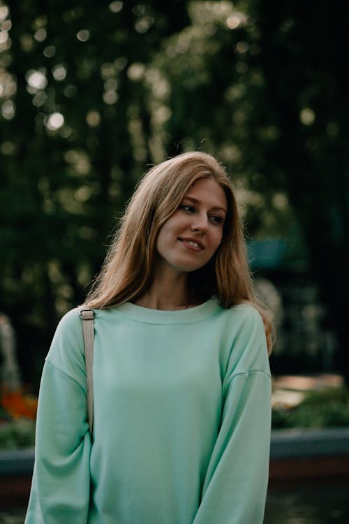 A Pretty Woman in Green Pullover