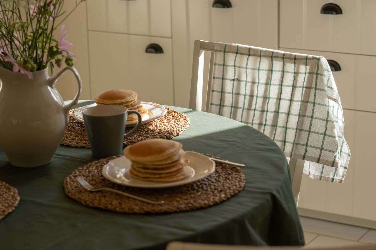 cozy-kitchen-breakfast-table Cozy kitchen table set for breakfast in natural light