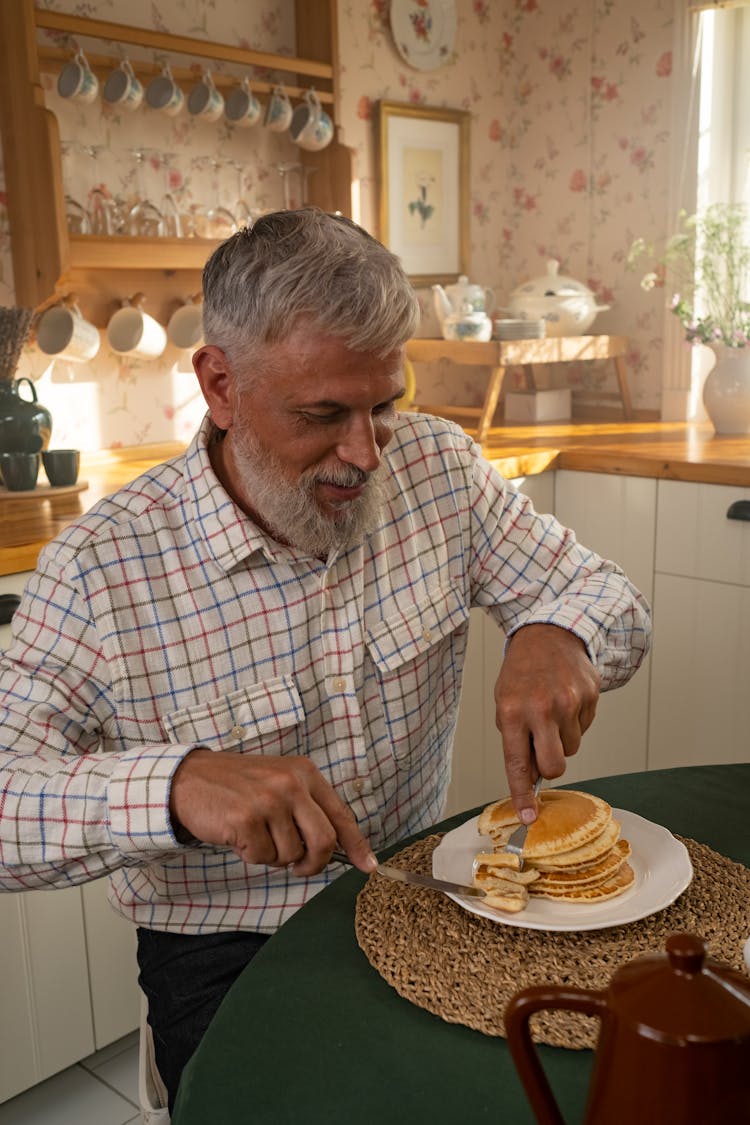 Gray Haired Man In Shirt Eating Pancakes