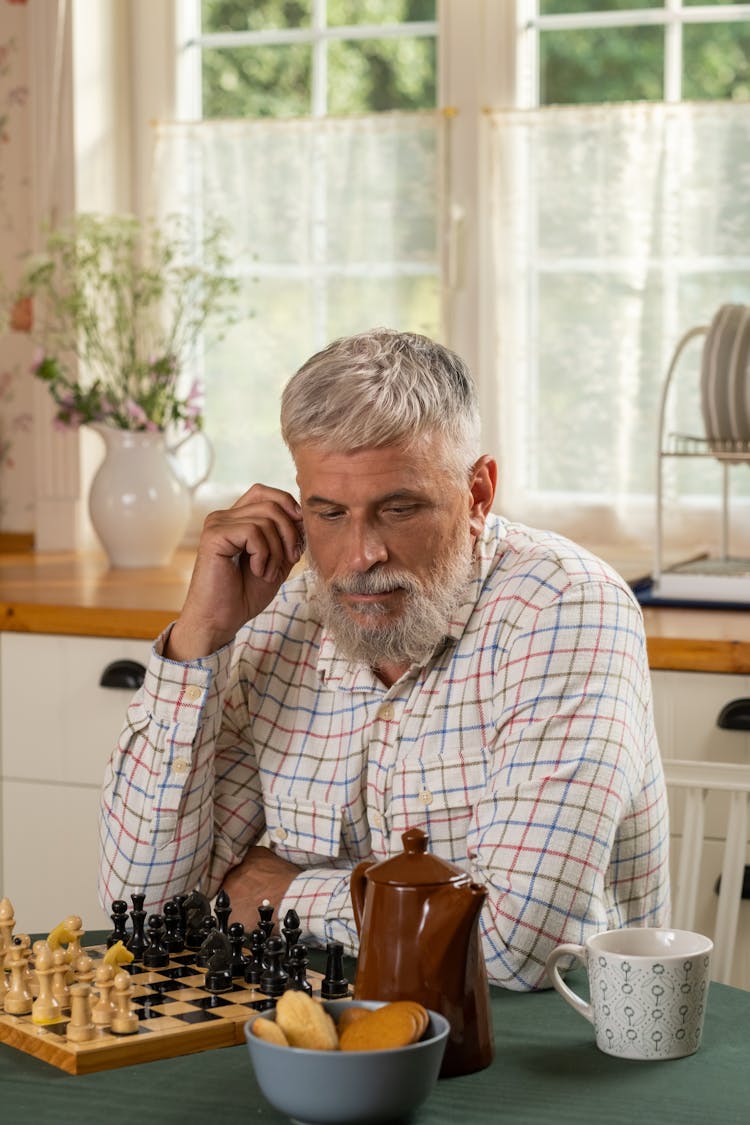 Elderly Man With Beard Playing Chess