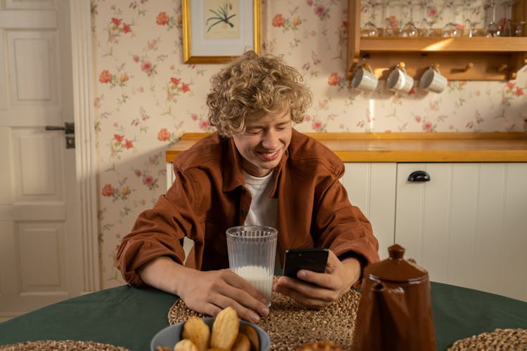 Portrait Of Smiling Teenager Holding Phone